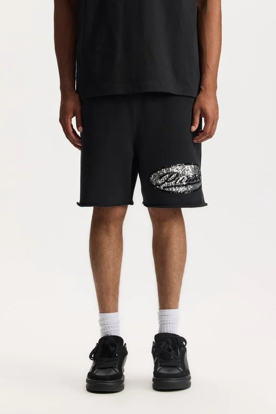 Pantaloncini con scritta in paillettes
