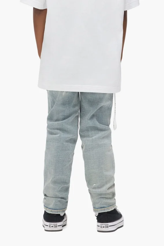 Pantaloni da bambino in indaco chiaro con effetto "paint repair"